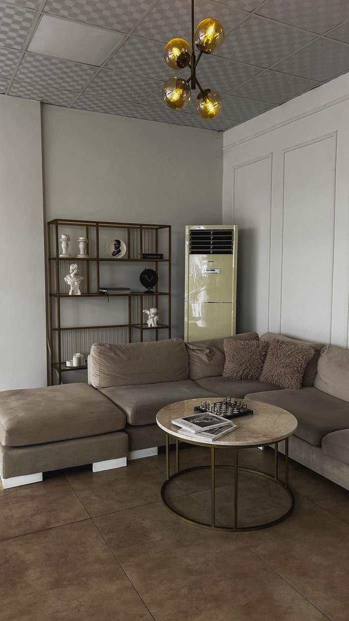 Contemporary living room featuring a brown sectional sofa, round coffee table, and stylish decor.