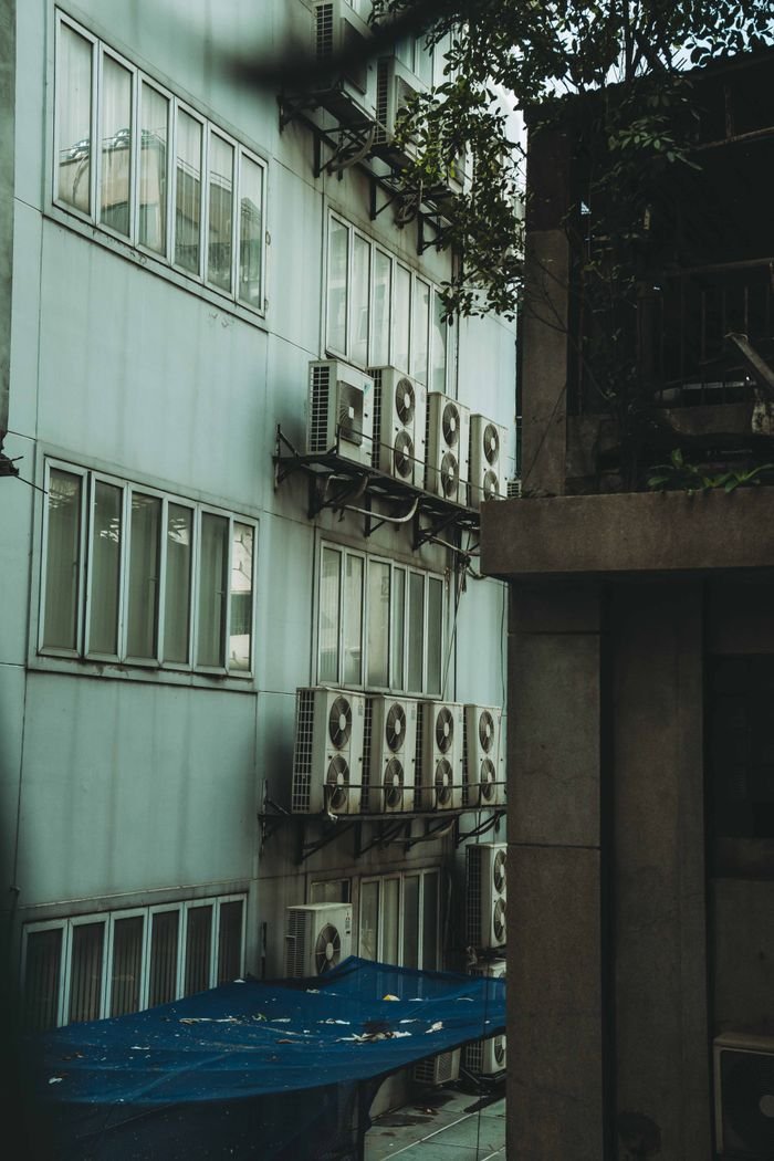 Side view of a building with multiple air conditioning units in Ho Chi Minh City.