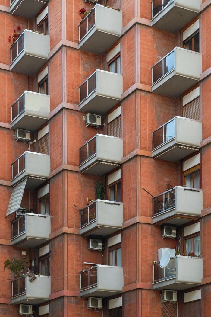 Side view of an apartment building showcasing multiple balconies.